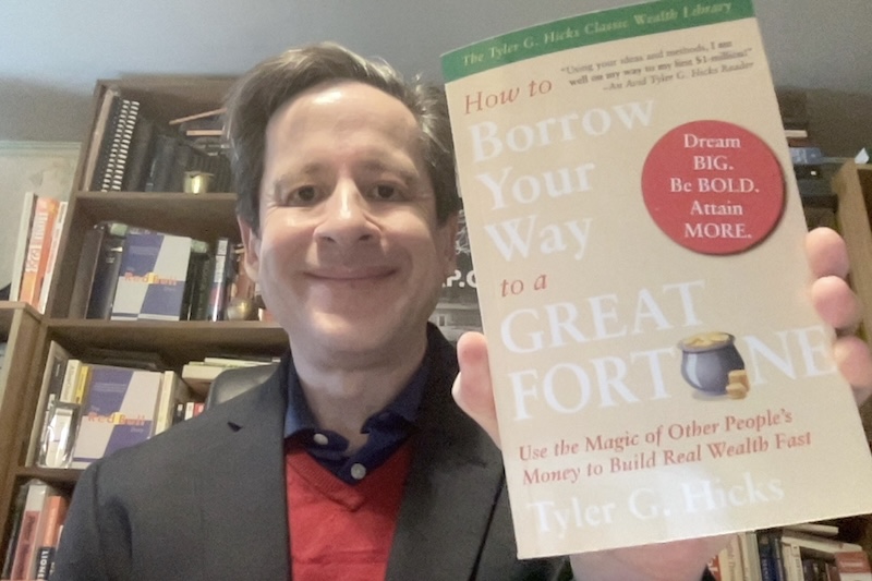 Publisher Anthony Raymond of International Wealth Success (IW$) proudly holds Tyler G. Hicks' classic "How to Borrow Your Way to a Great Fortune" in its newly updated edition.